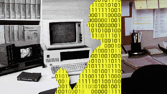 A gif of binary code inside the silhouette of a person sitting at a desk using a computer in an office environment.
