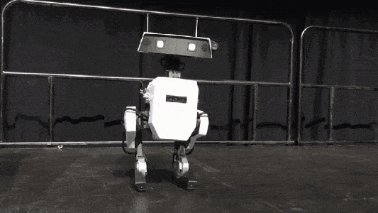 A small robot is dancing on a stage